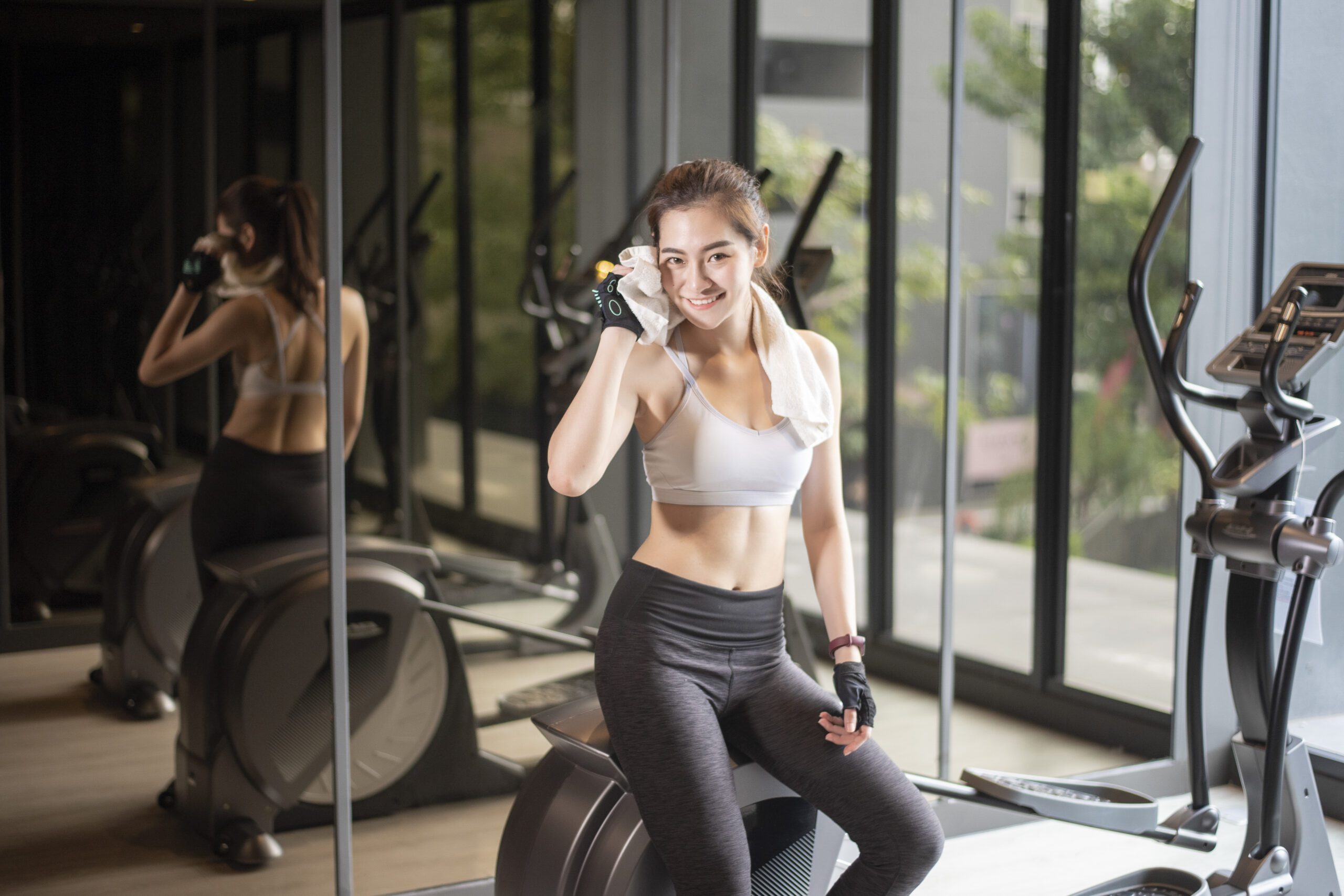 Beautiful asian woman is doing exercise in the gym