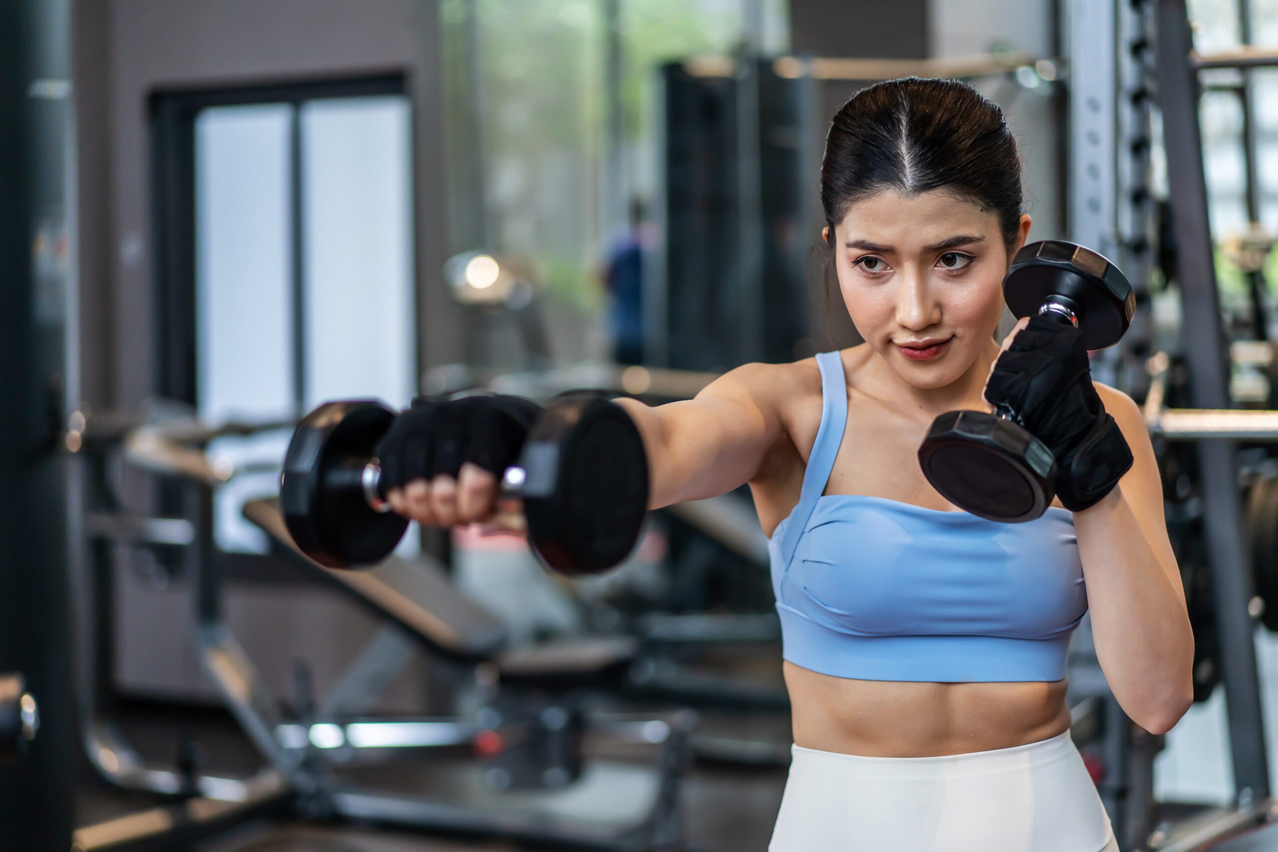 Portrait of a confident young asian fitness woman doing exercise