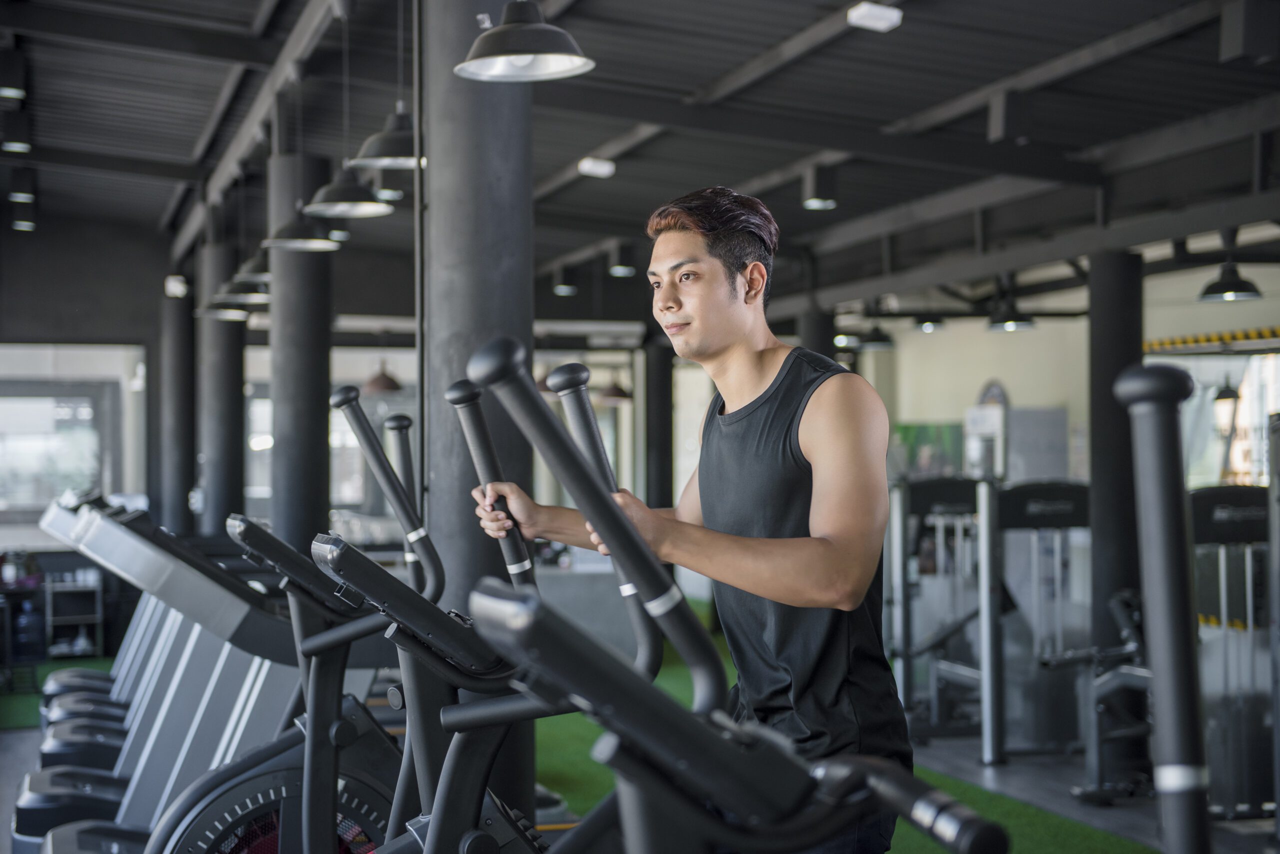 handsome man running on a treadmill in a gym